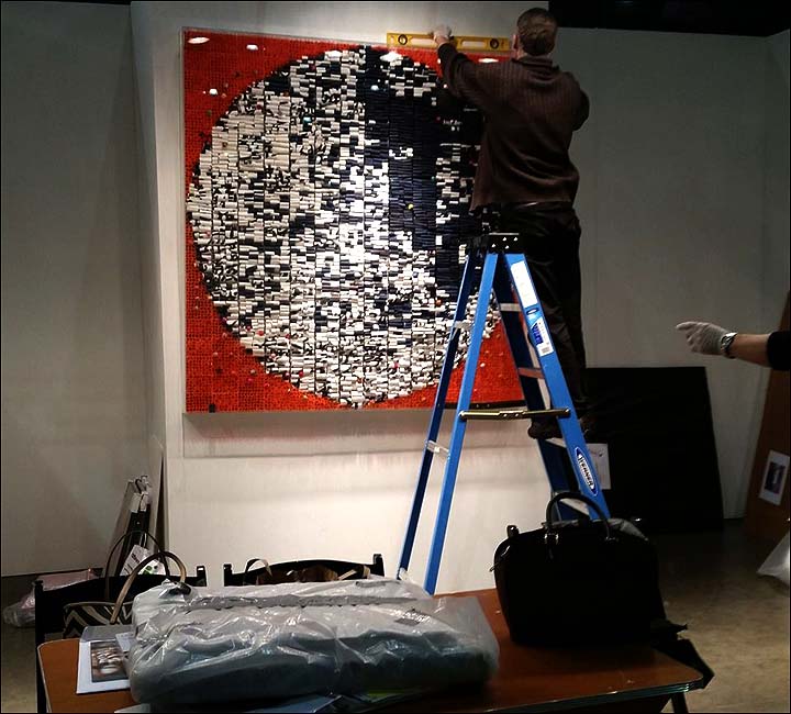 installing large artwork for exhibition