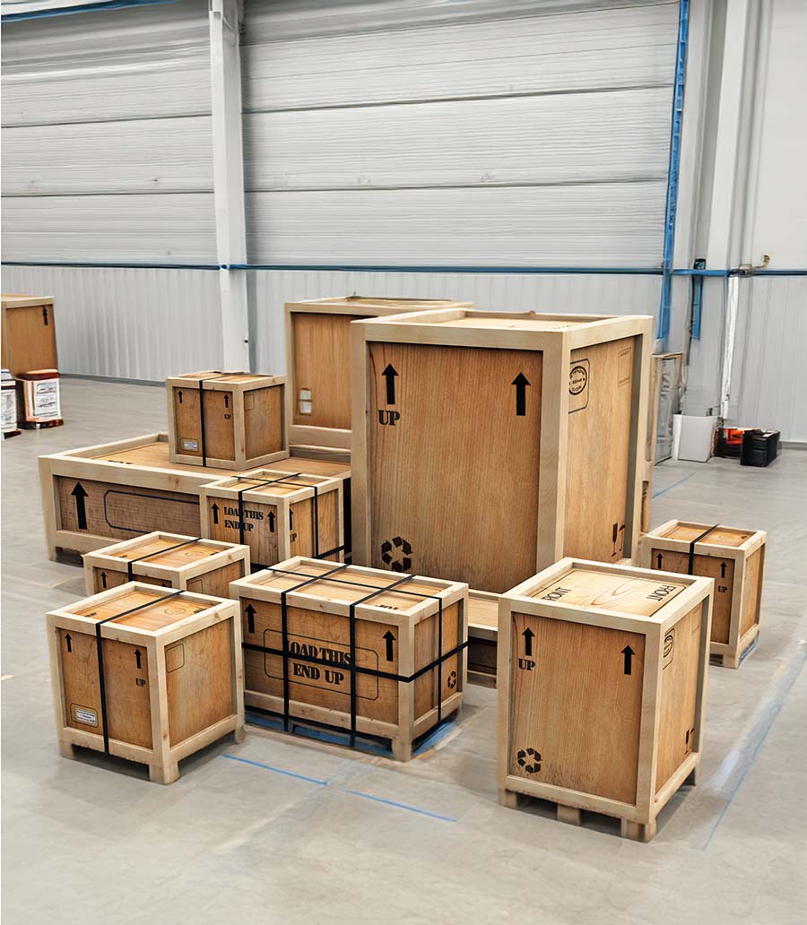 Consignments of multiple crates staged for shipment in Goodman Packing & Shipping Warehouse.